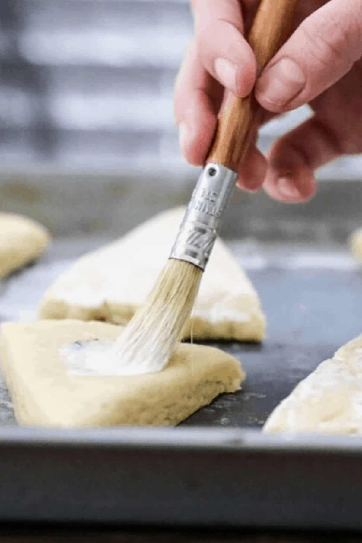 pastry brush with milk on scones