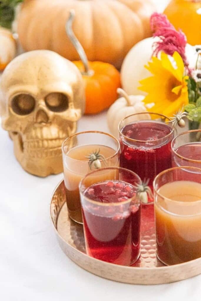 apple cider pomegranate sparklers with spooky decorations