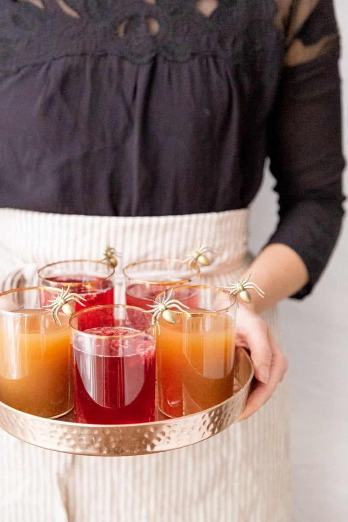 apple cider pomegranate sparklers with spiders on the glasses