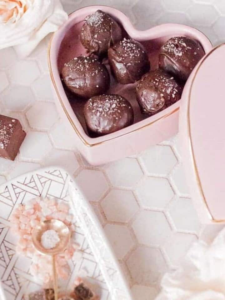 salted dark chocolate truffles in a heart shaped box on a table