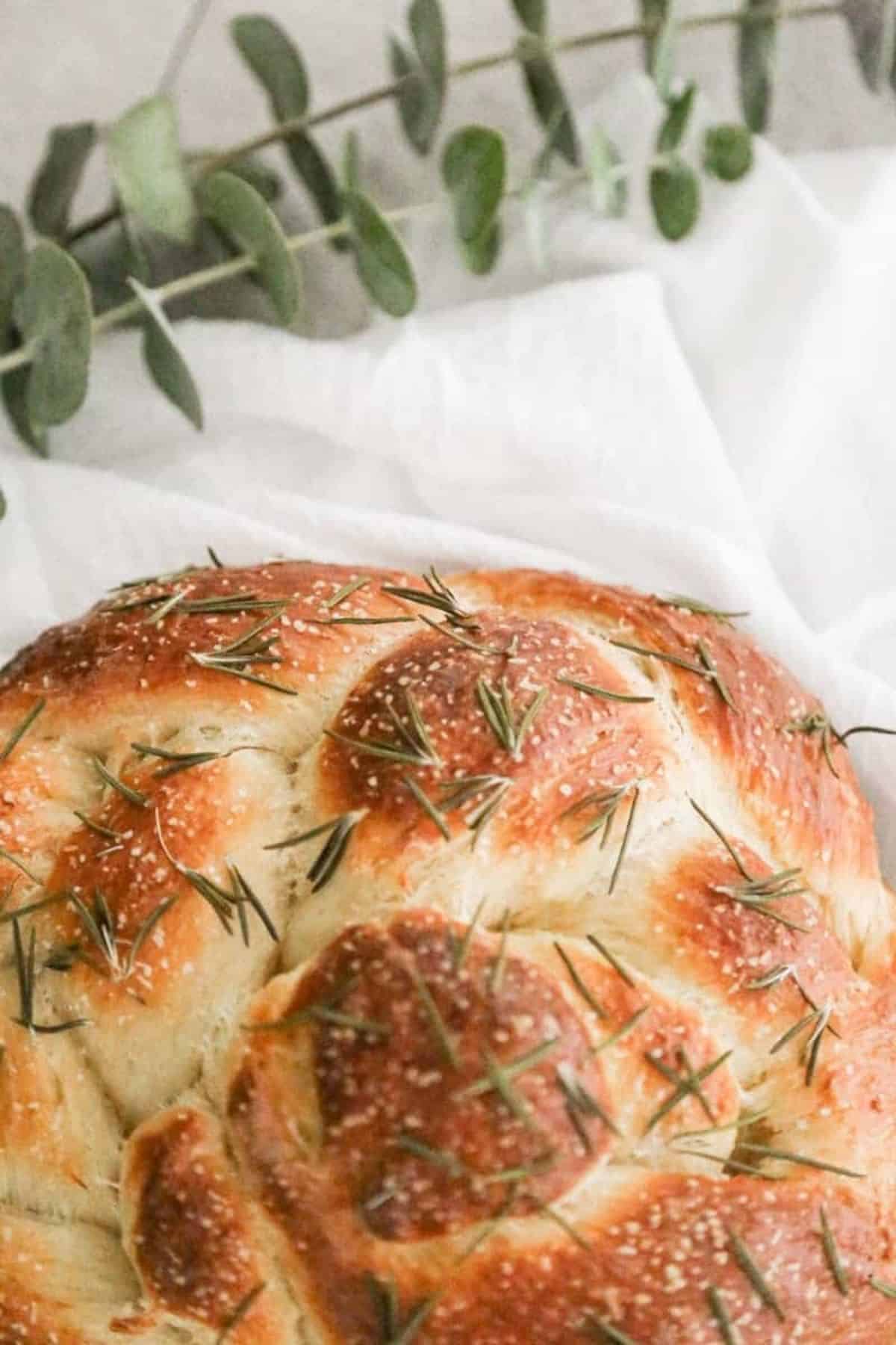 baked challah with rosemary on top