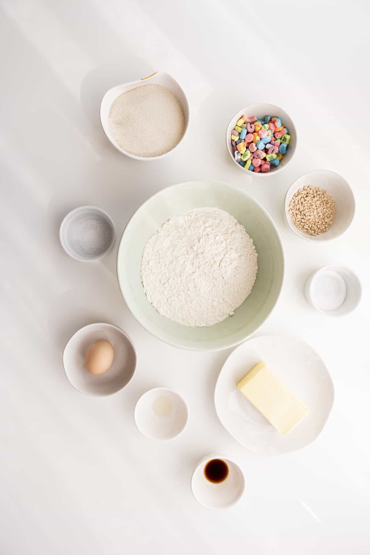 ingredients in ceramic bowls on a white table with sun beams on them