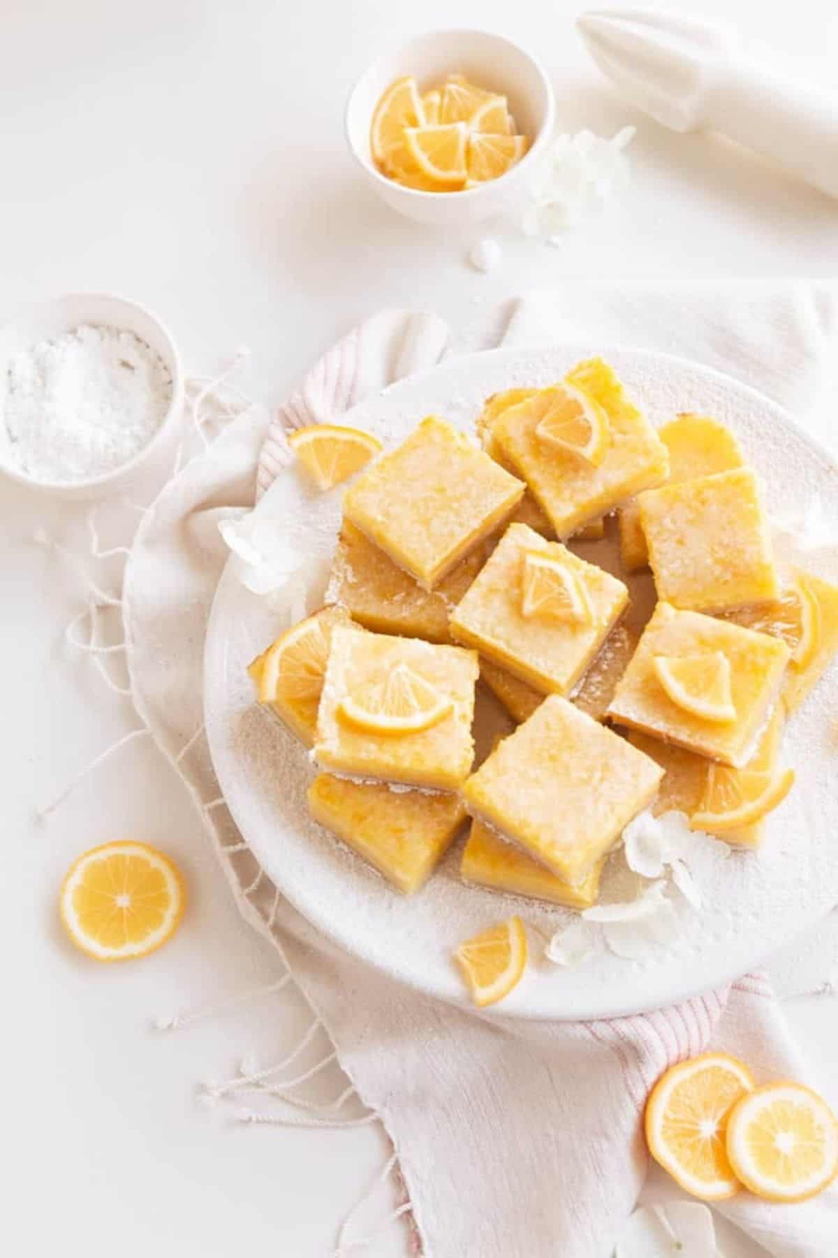 lemon bars with shortbread crust on the little market plate with lemons