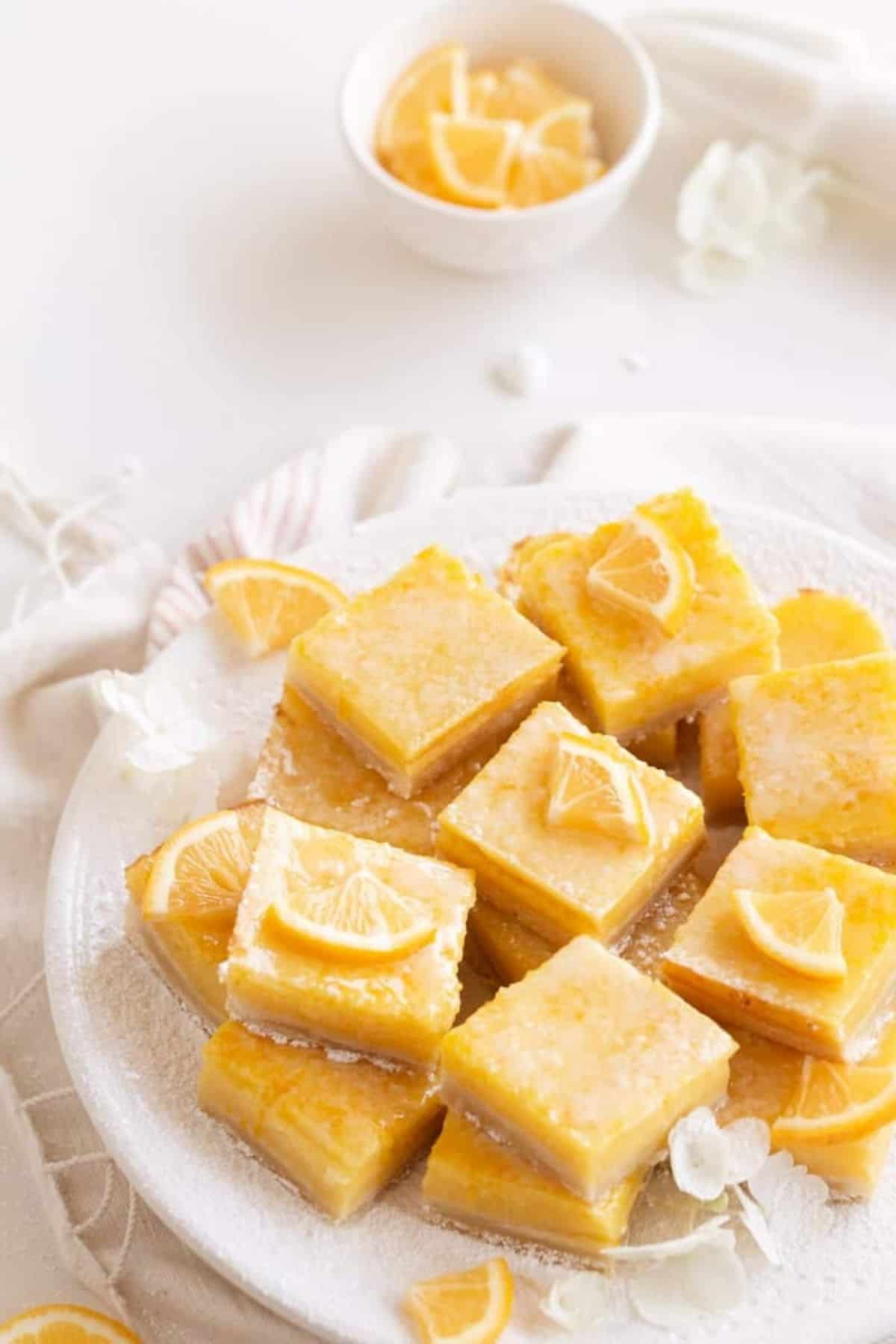 lemon bars with shortbread crust on the little market plate with lemons