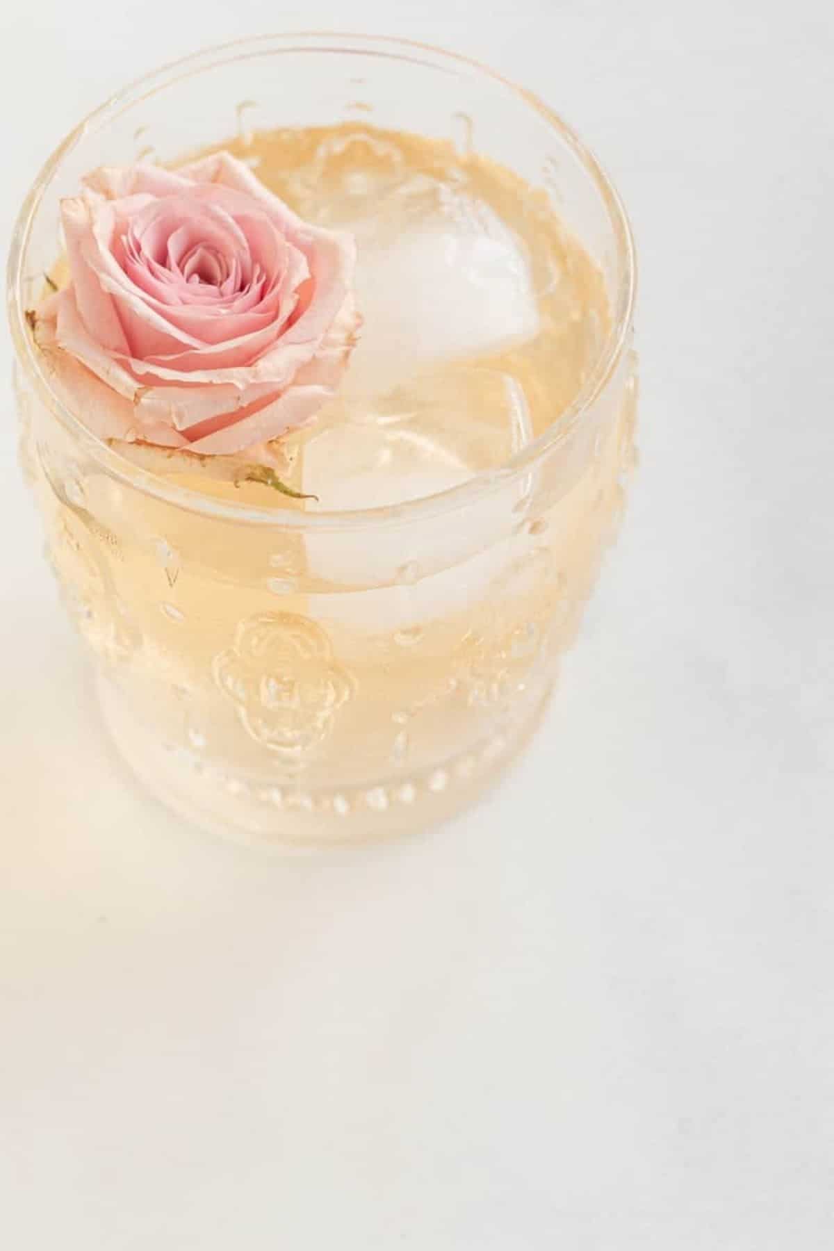 spritzer in a glass with ice and rose