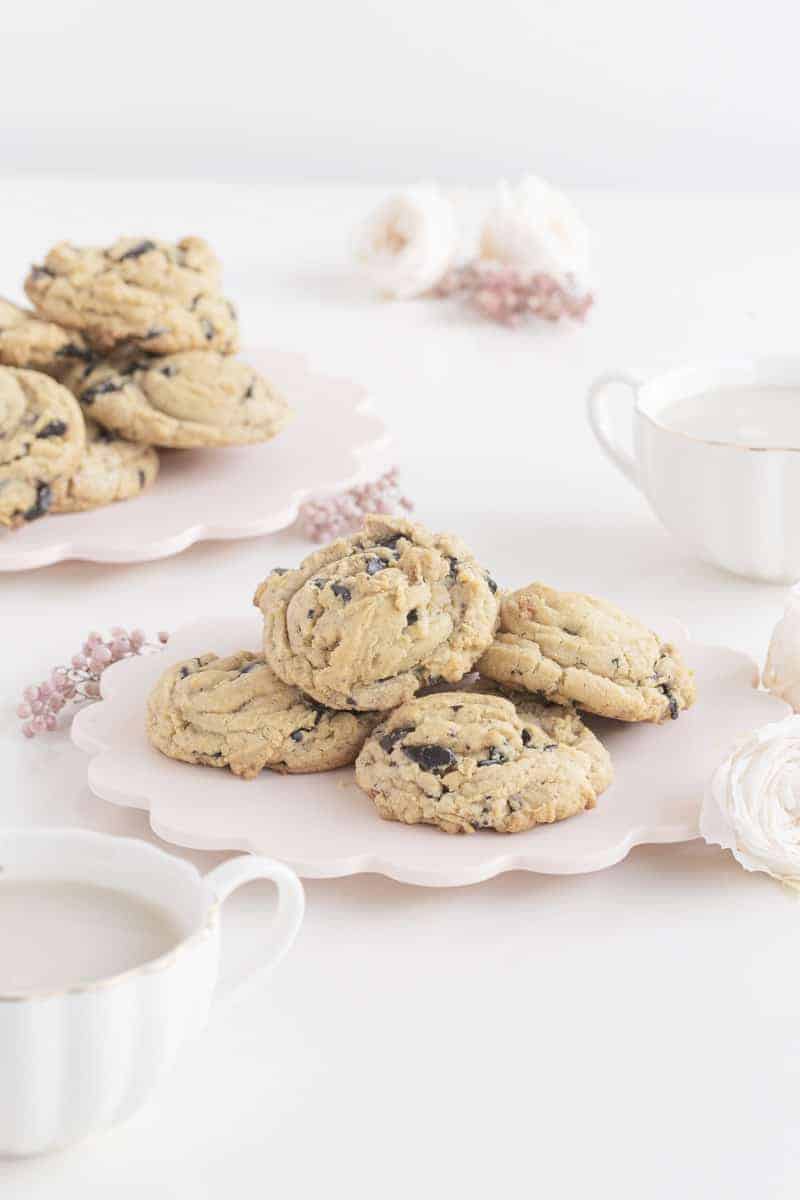 cookies on plate and mugs of milk