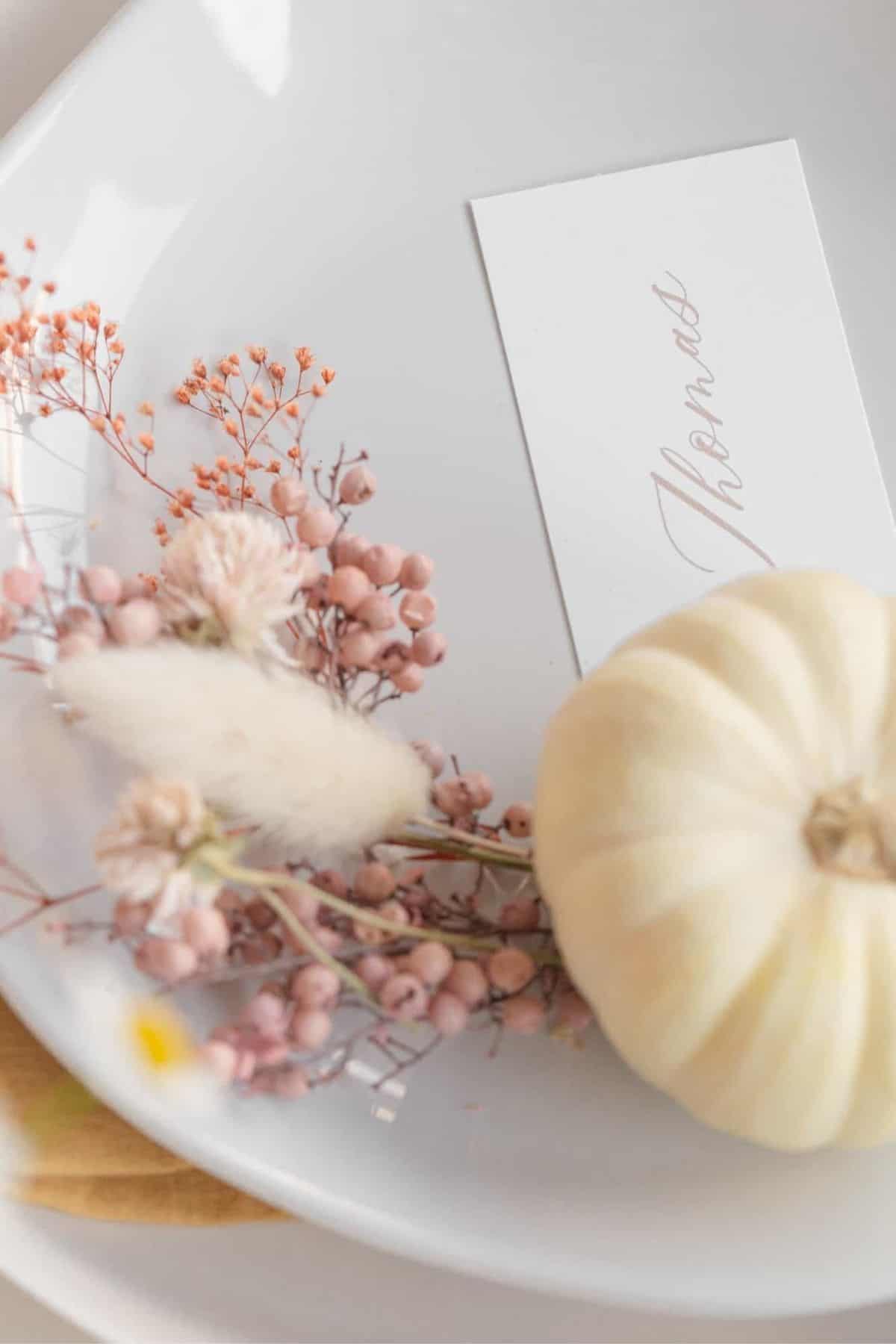 Thanksgiving place setting with pumpkin and dried flowers