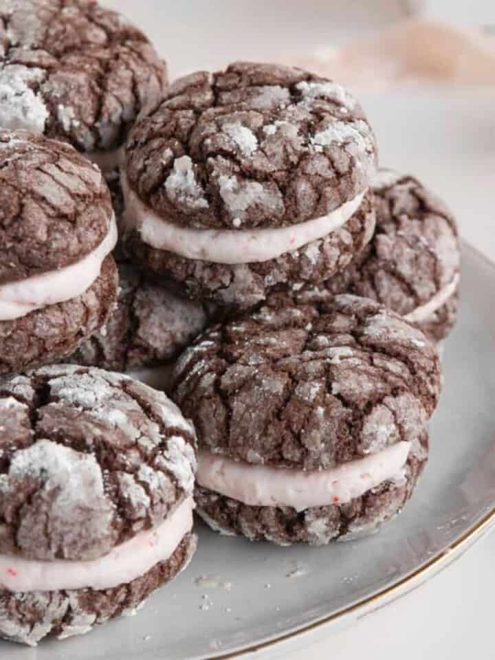 Chocolate crinkle cookies with peppermint buttercream filling on plate with decor