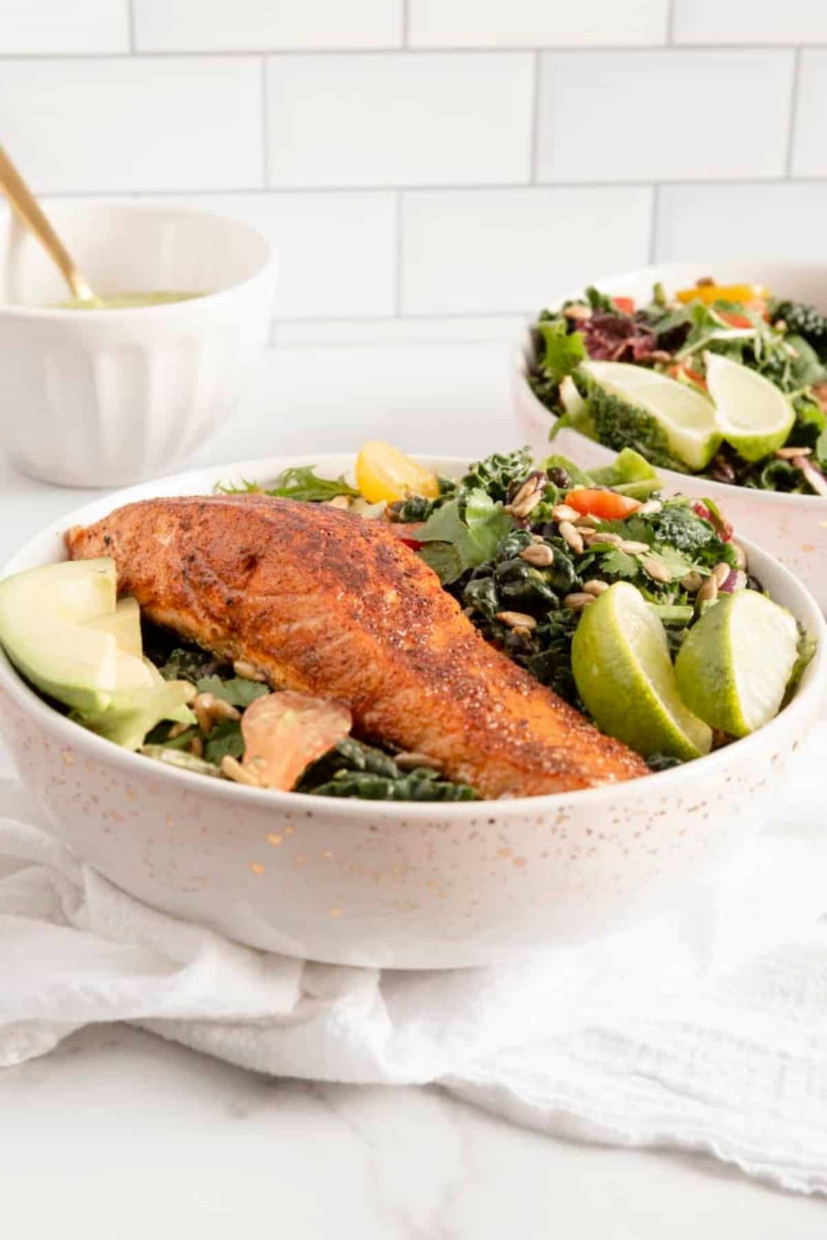 salmon on salad in two bowls