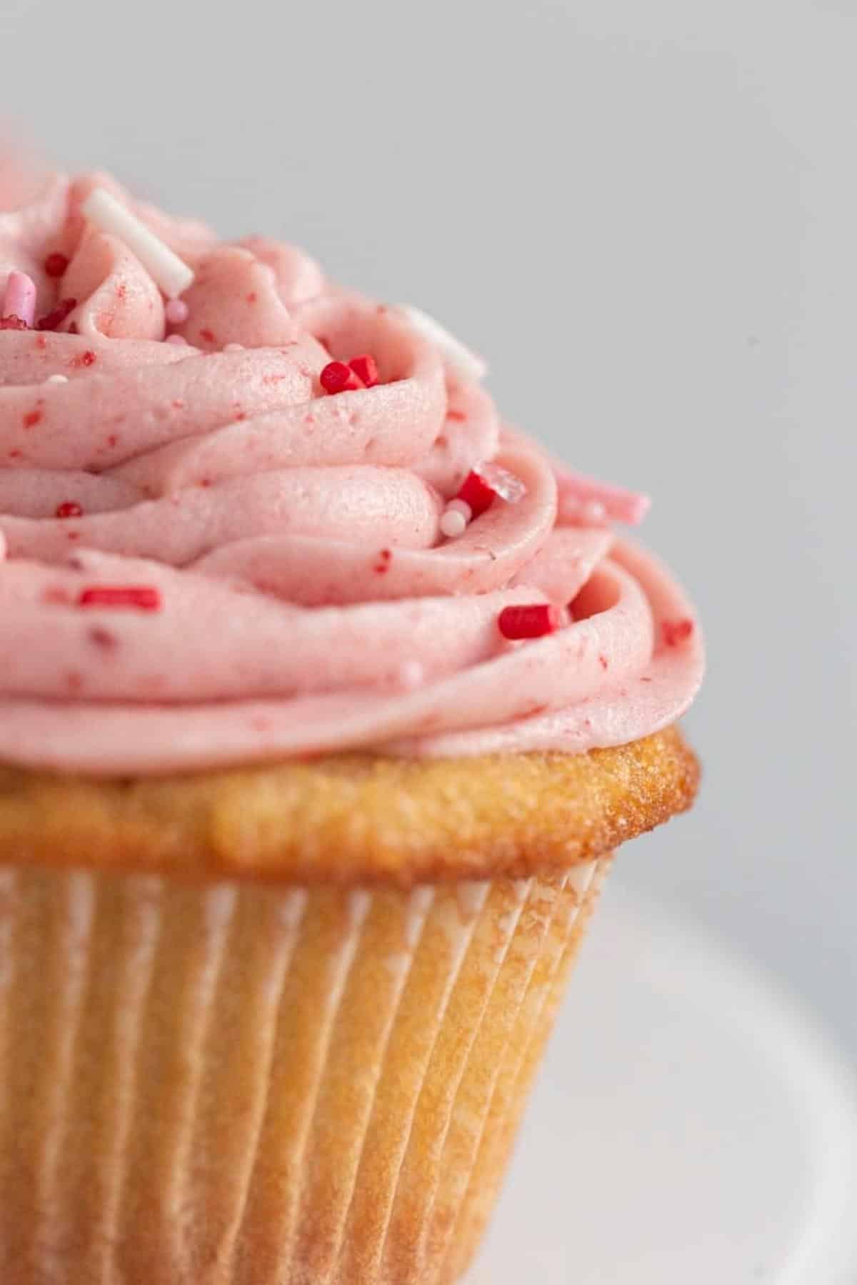 cupcake with strawberry frosting and sprinkles