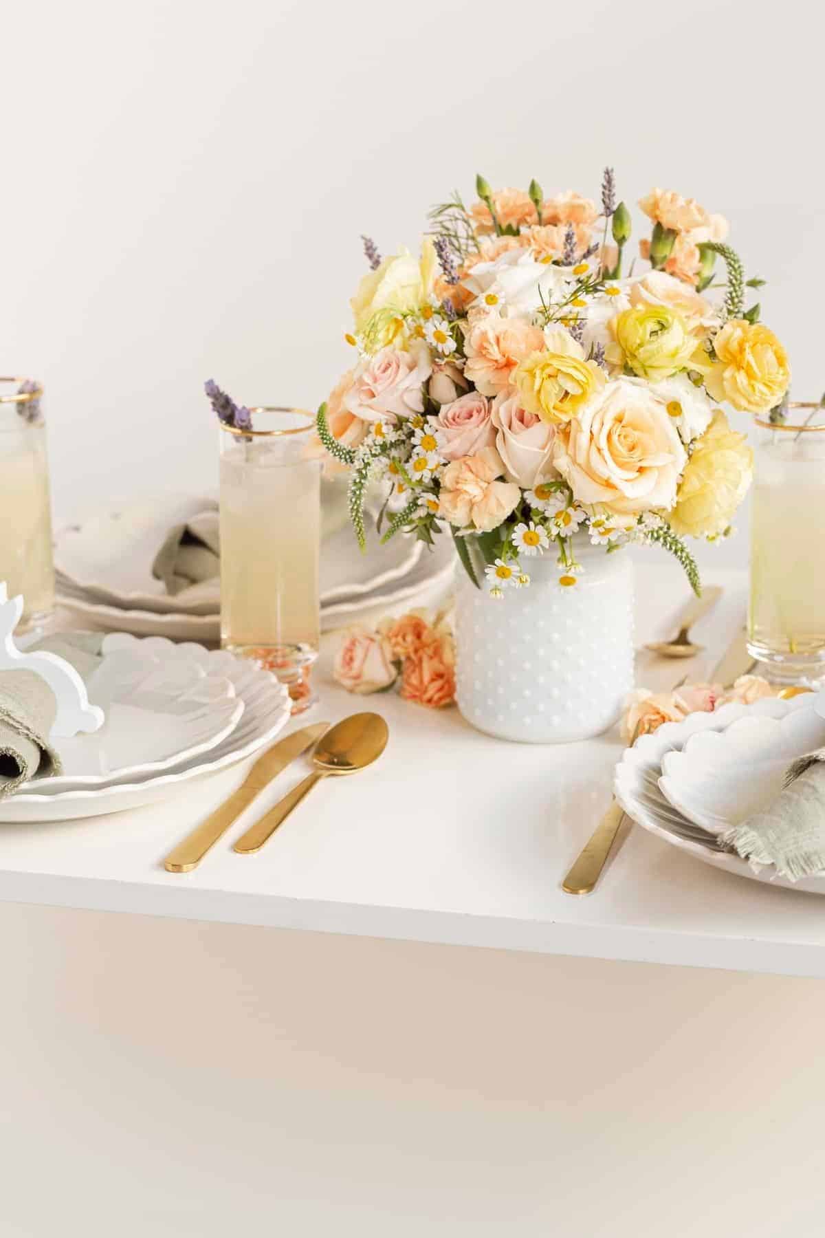 Easter tabletop decor with cocktails, plates, and flowers