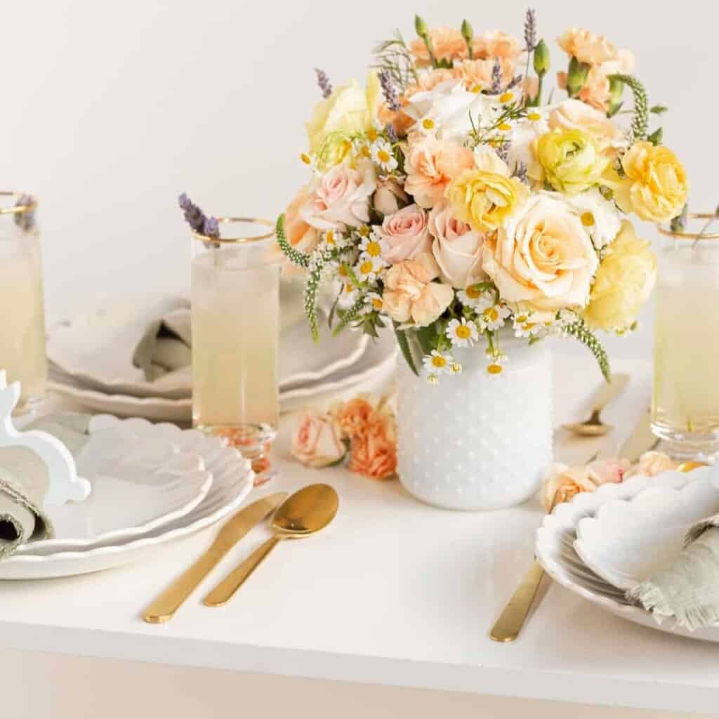 Easter tabletop decor with cocktails, plates, and flowers