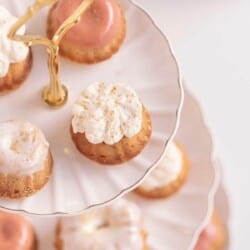 Honey Cupcakes on a cake stand with a vase and flowers