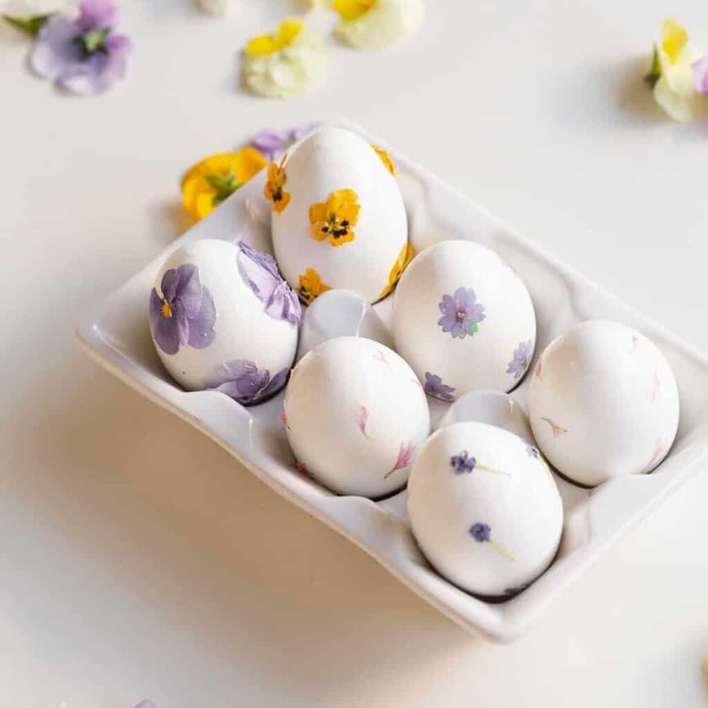 easter eggs in a tray with flowers
