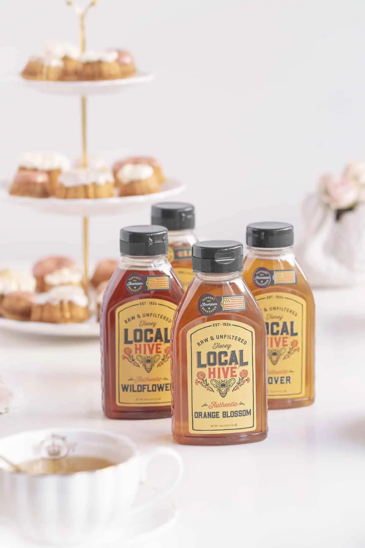 local honey in bottles with honey cakes and tea
