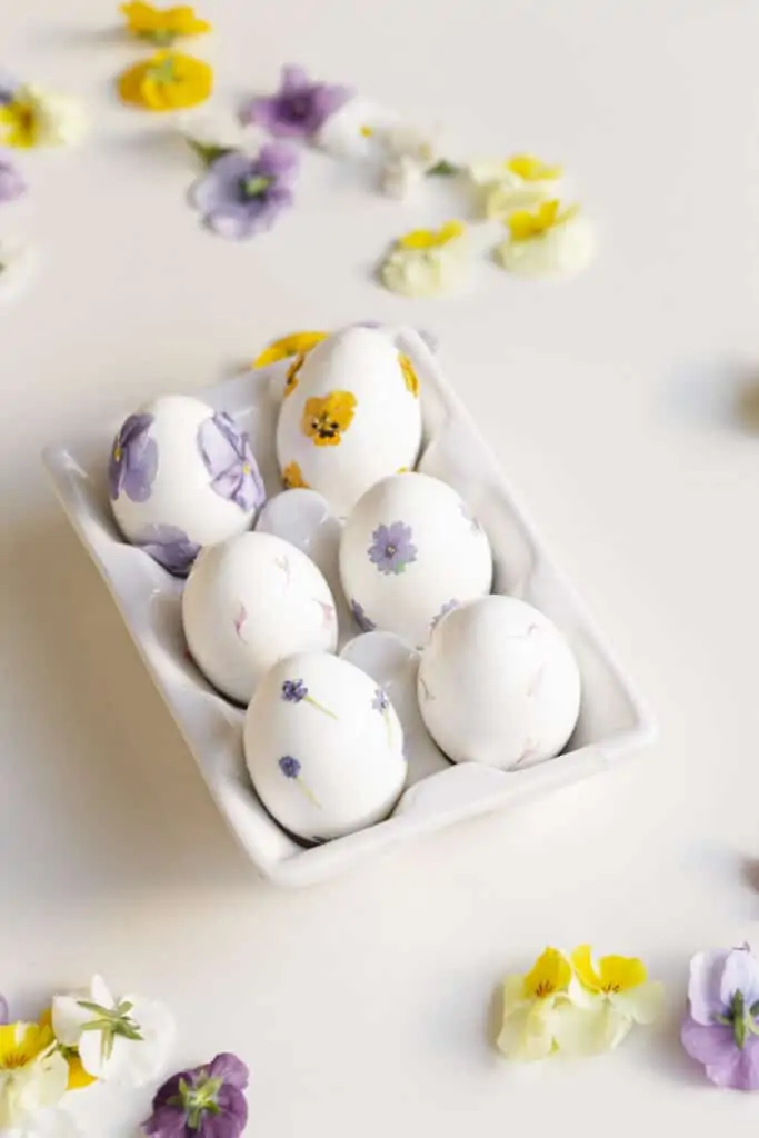 pressed flower easter eggs in a tray