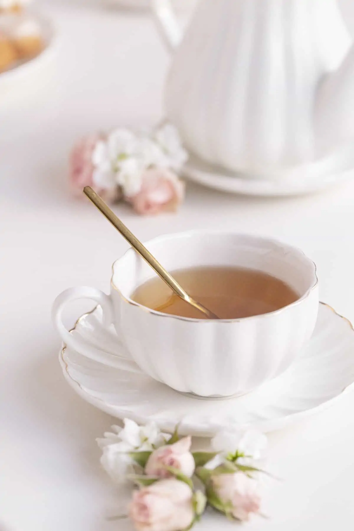 chamomile tea with honey in a cup and sauce with flowers