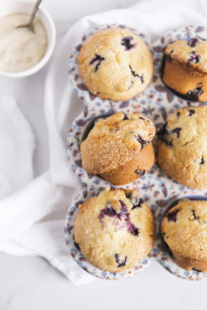 muffins in a ceramic muffin pan with a cloth