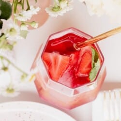 Rosé Sangria in a pitcher filled with berries and lemon slices