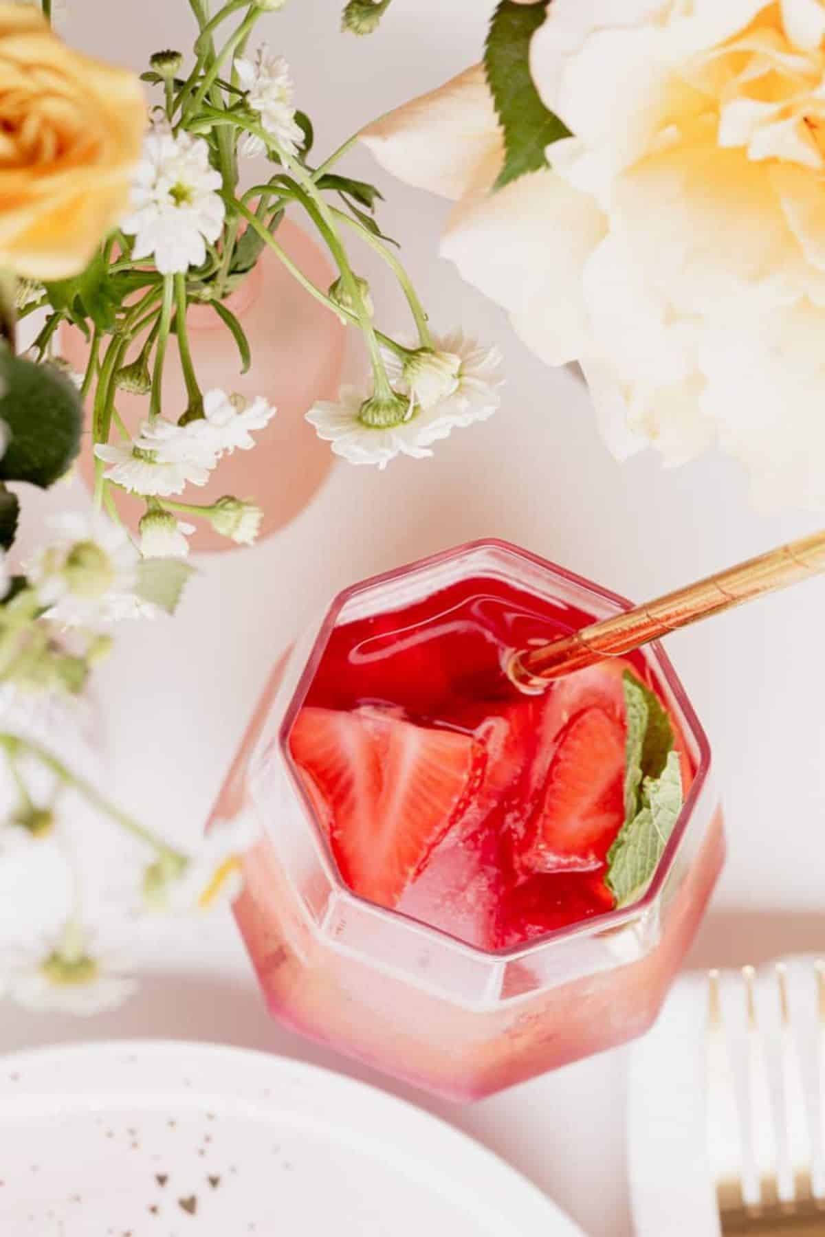 frozen berry sangria in glassware on a set table with flowers