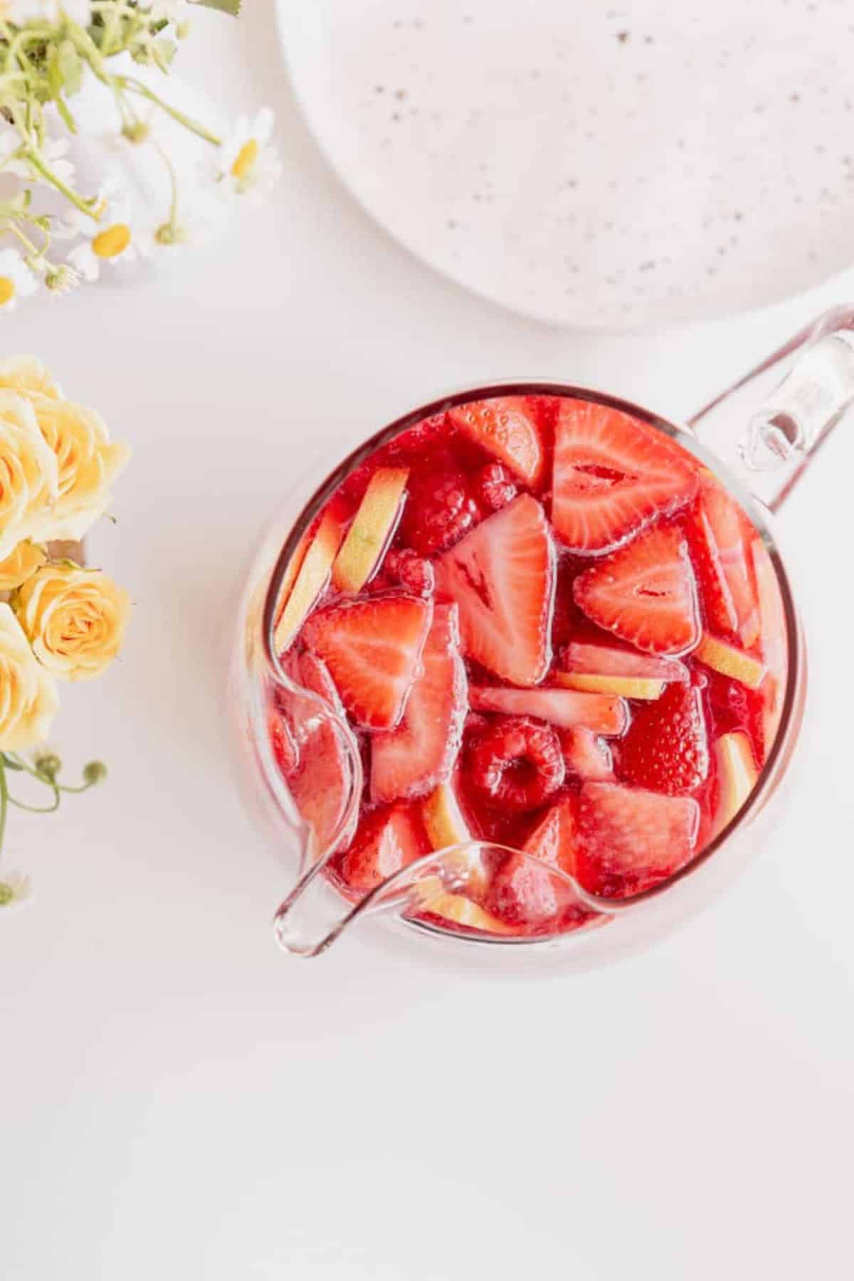 rosé sangria with vodka overhead in a pitcher with berries and lemons