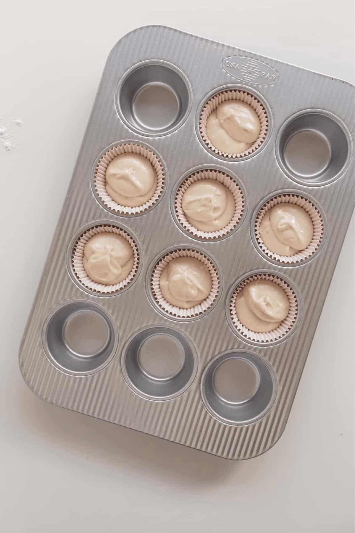 7 vanilla cupcakes in tin with water in 5 empty wells