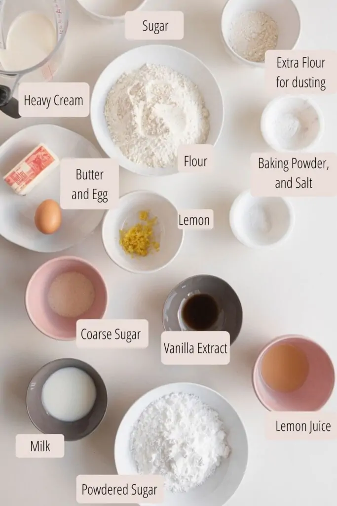 ingredients in bowls for lemon scones on a white surface