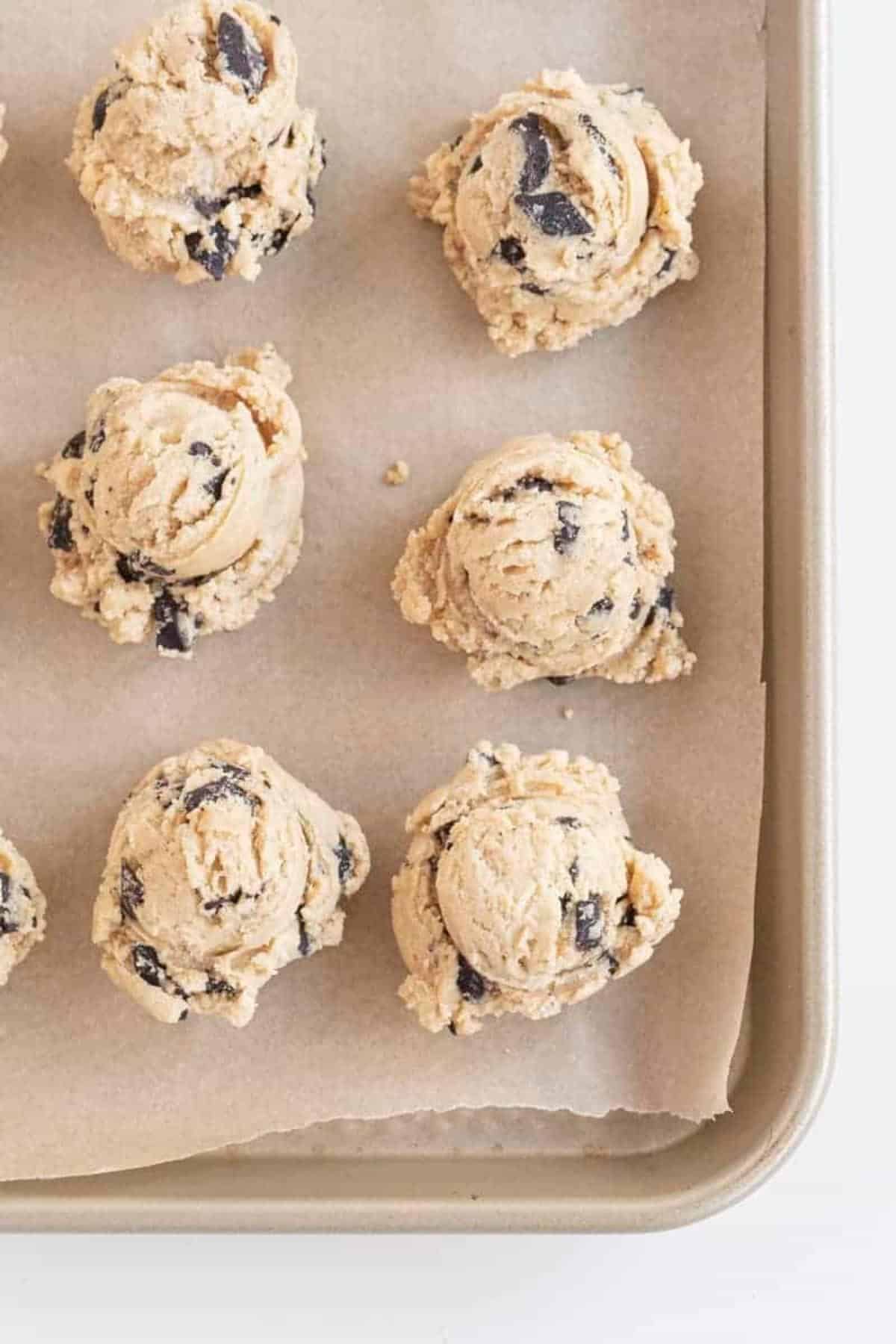 cookie dough balls on baking sheet