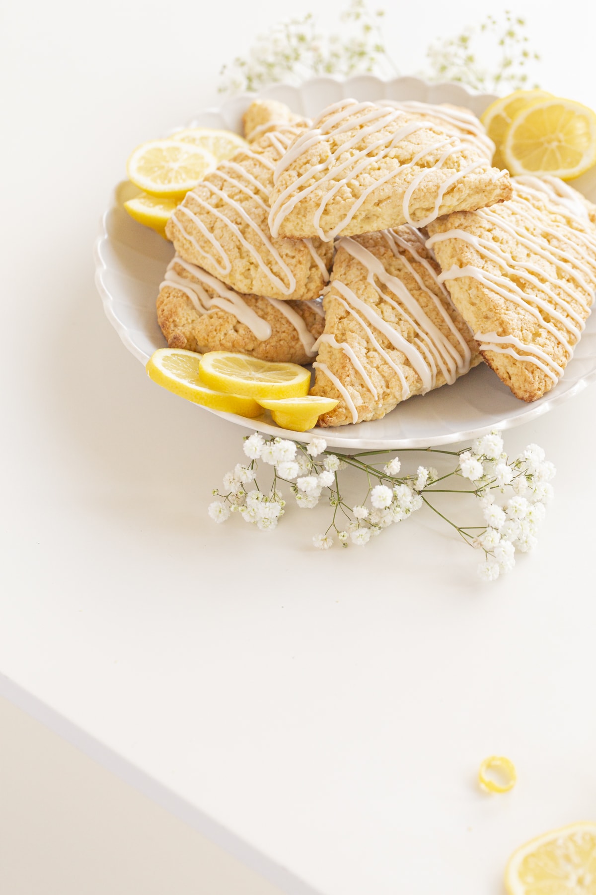 lemon scones on a plate with lemons and flowers