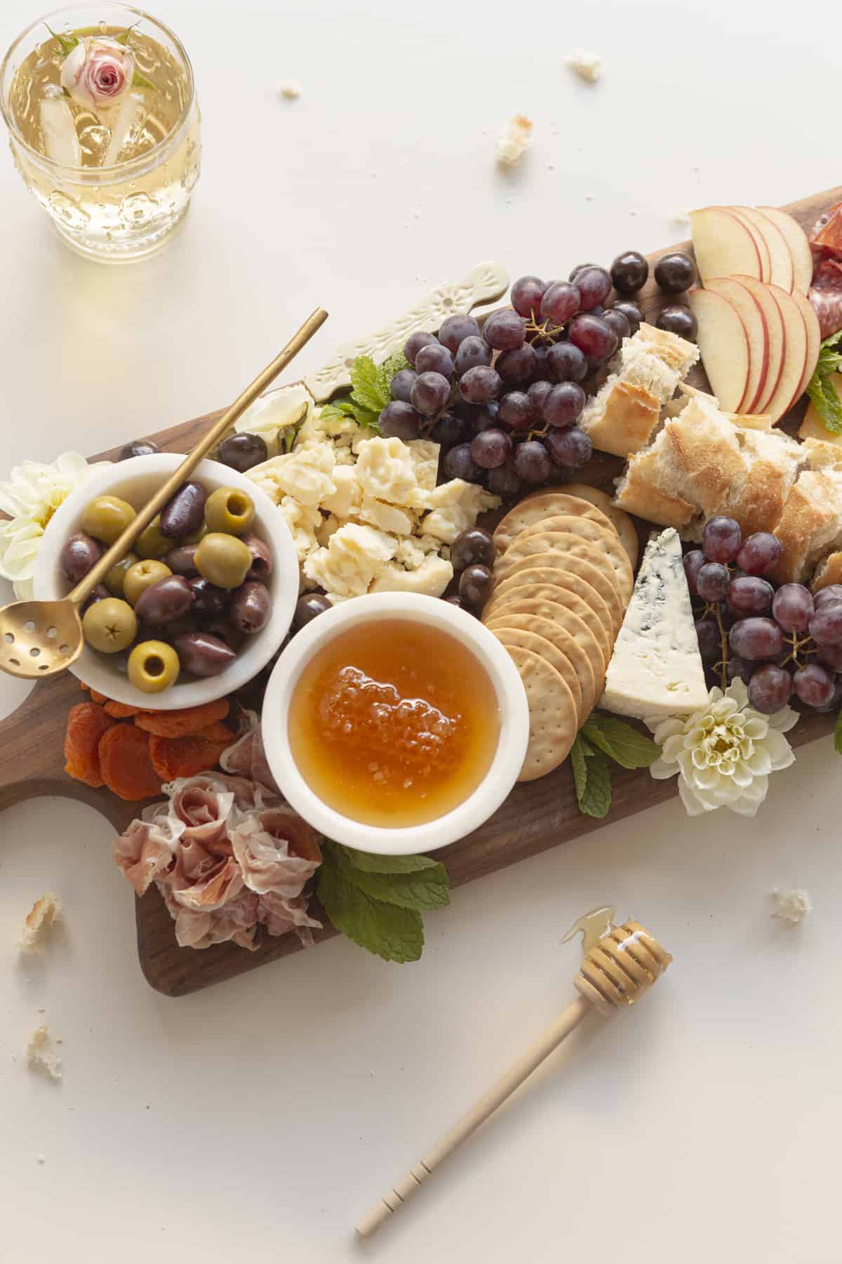 small charcuterie board with edible flowers and mint and honey