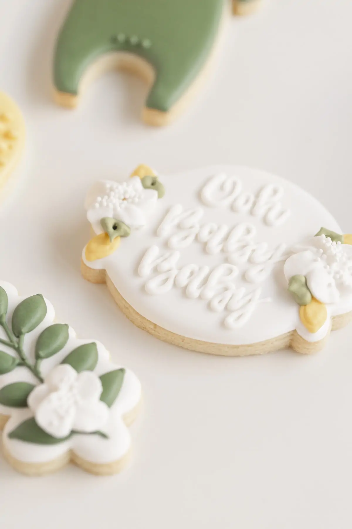 lemon baby shower cookies with "oh baby baby" written on it