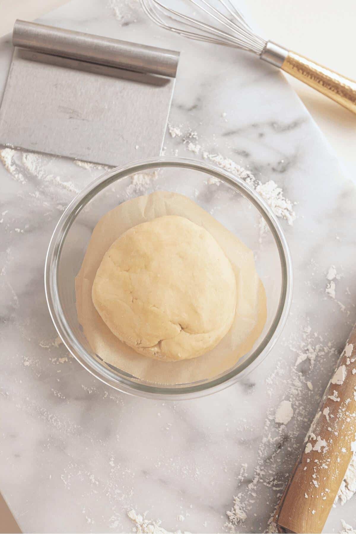 pie dough in a glass container for the fridge