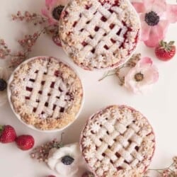 strawberry pies on a white surface with flowers