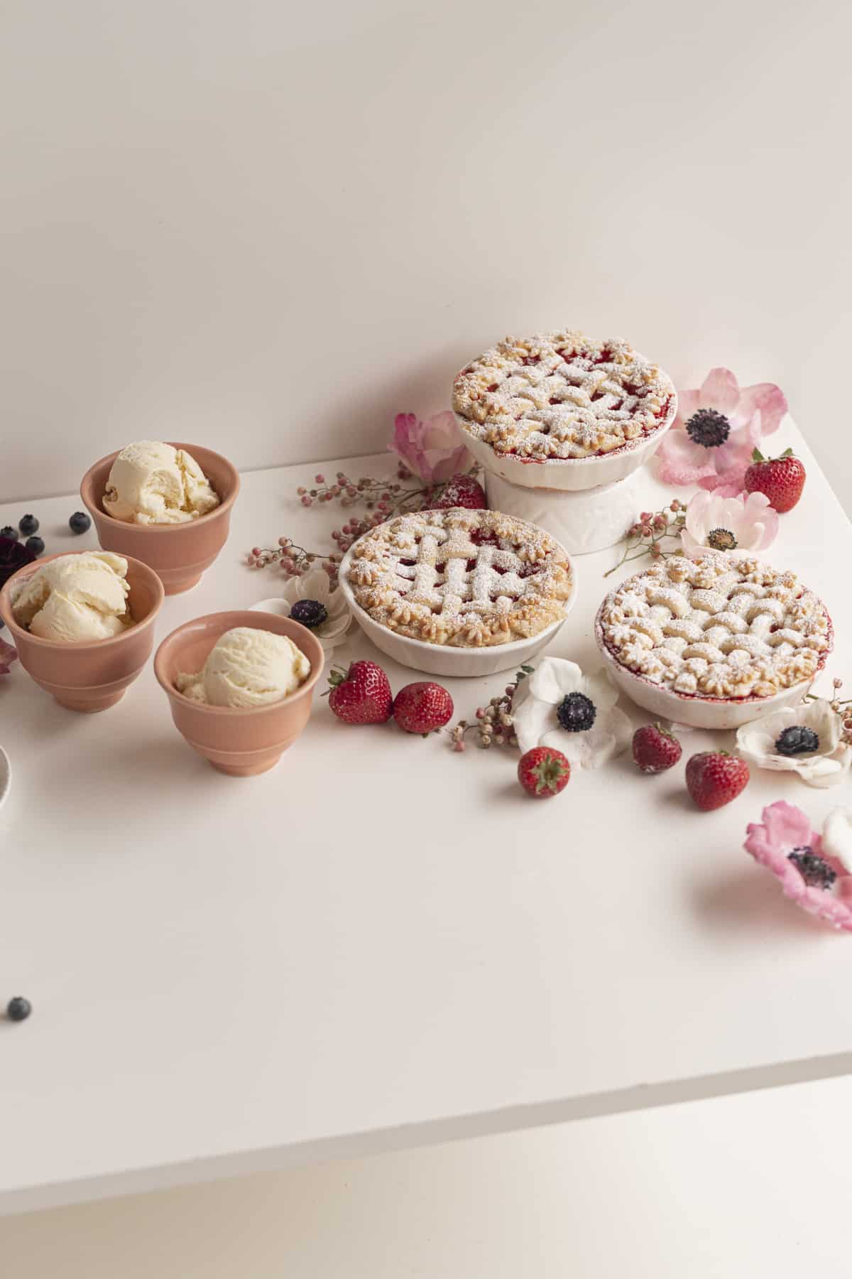 pies and ice cream in ceramics on a table with flowers