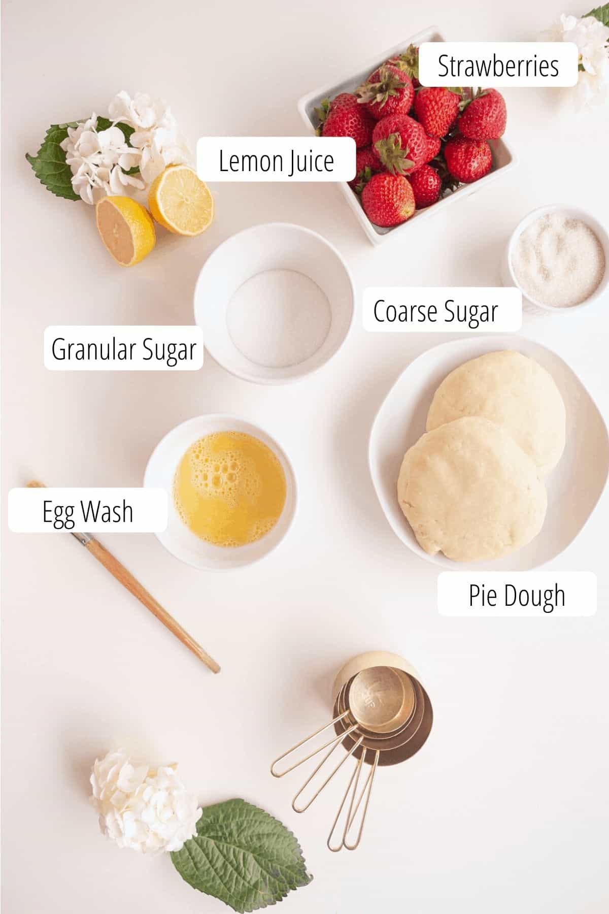 ingredients for strawberry pie, strawberries, pie dough, sugars, lemon, egg wash