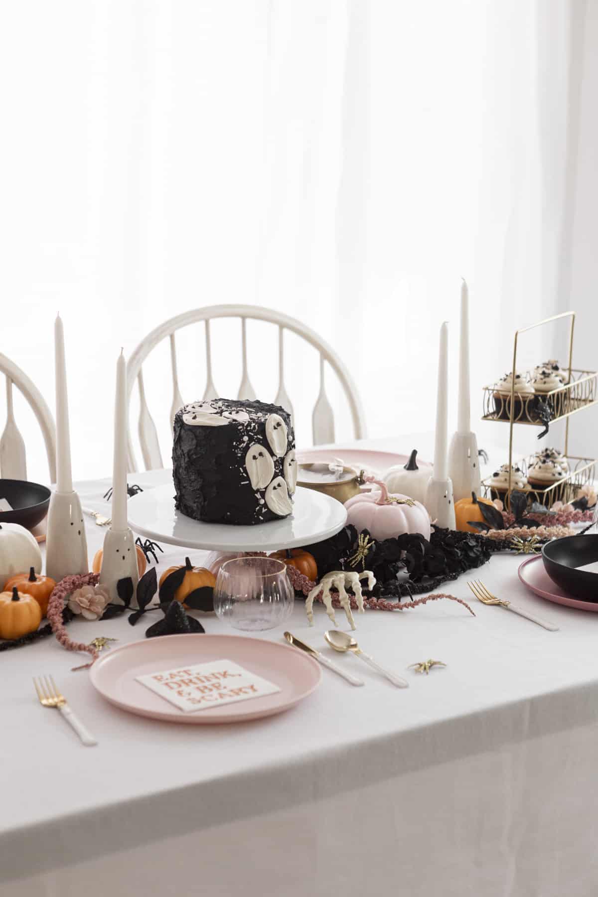 halloween table decorations with ghost candlesticks and faux flowers