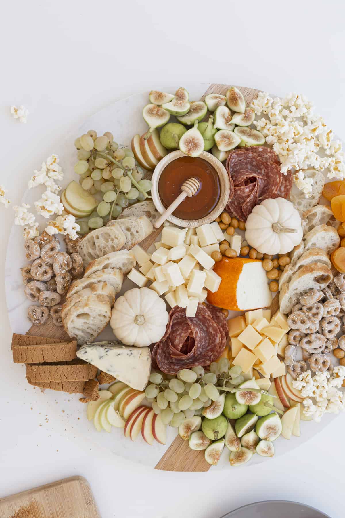 fall charcuterie board with cheese, meats, pumpkins