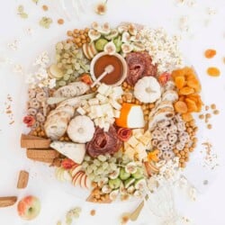 halloween charcuterie board with pumpkins and skeleton hands