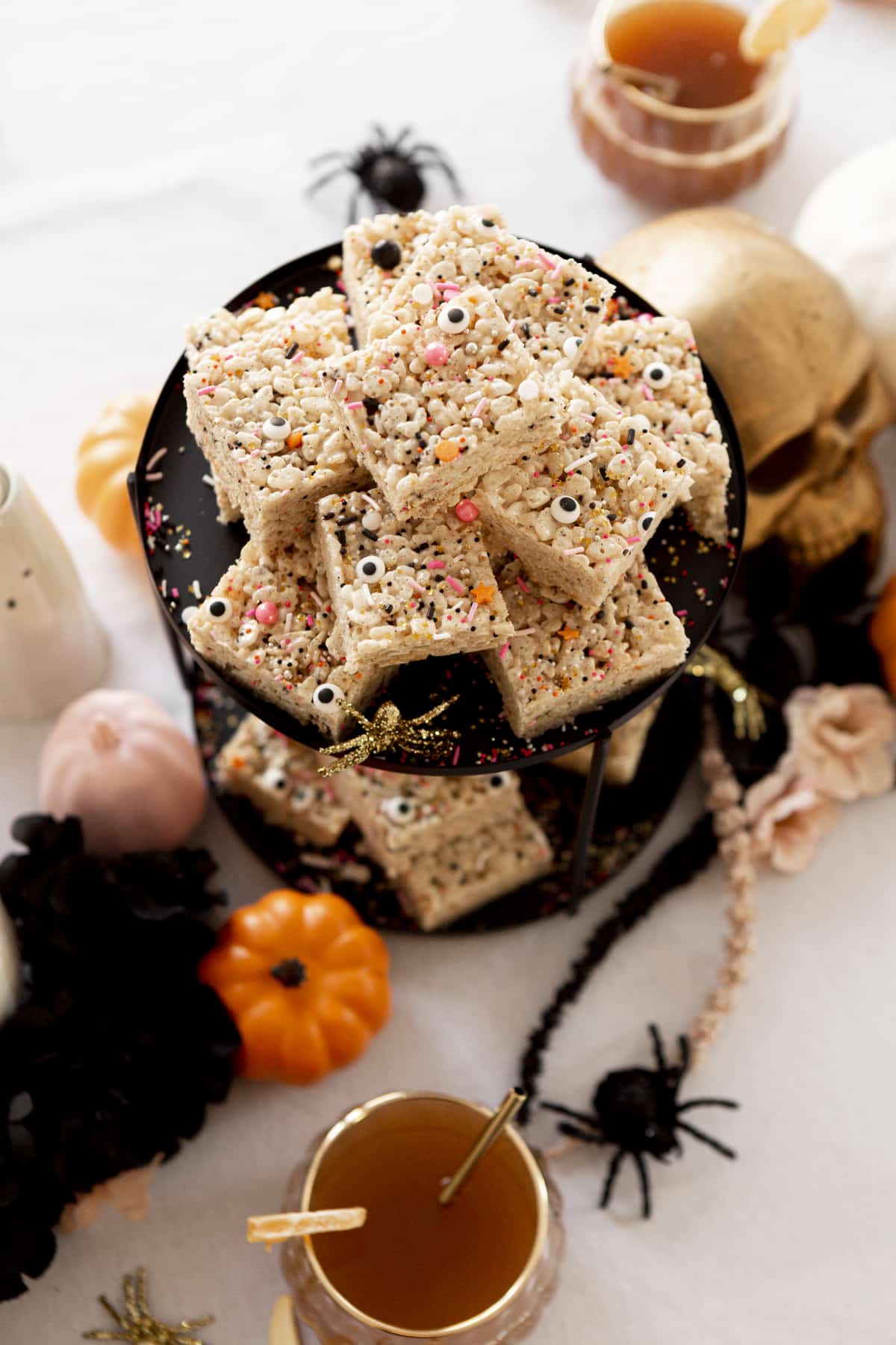 rice krispie treats on a black tray on halloween table