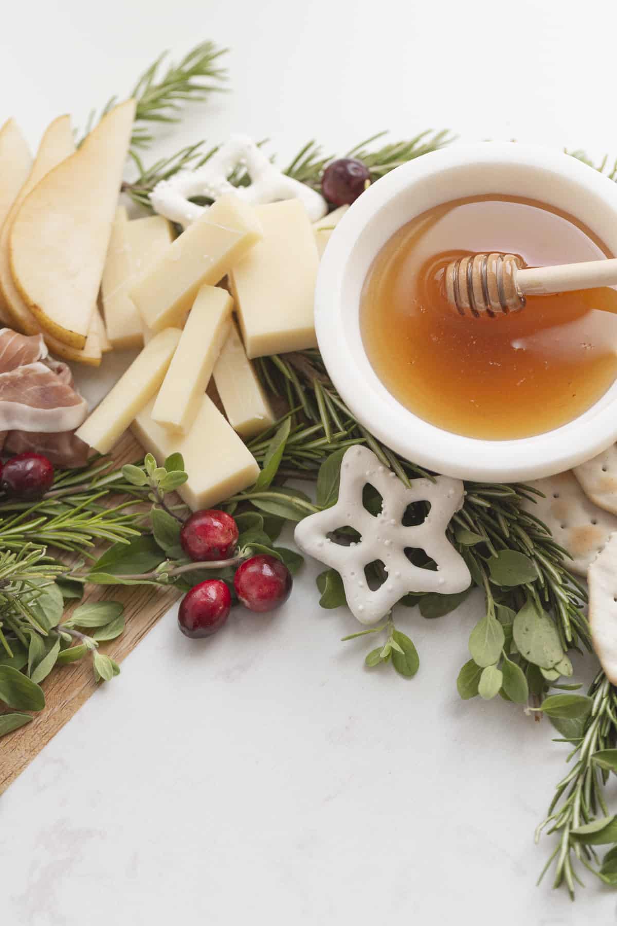 honey and cheese on rosemary with cranberries and a star pretzel