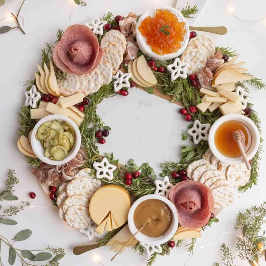 a charcuterie board made into the shape of a wreath on a circular board