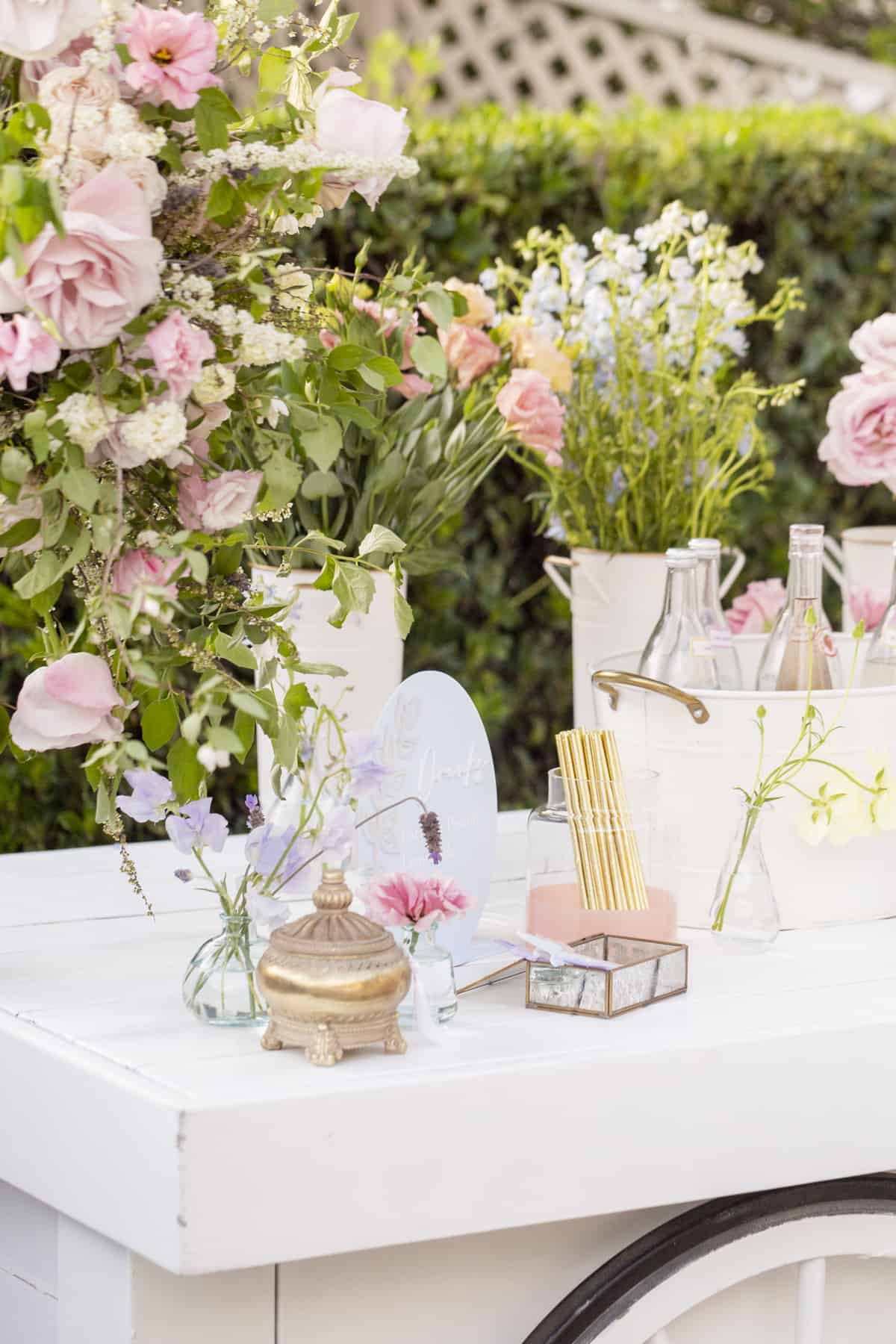 white cart with flowers and drinks