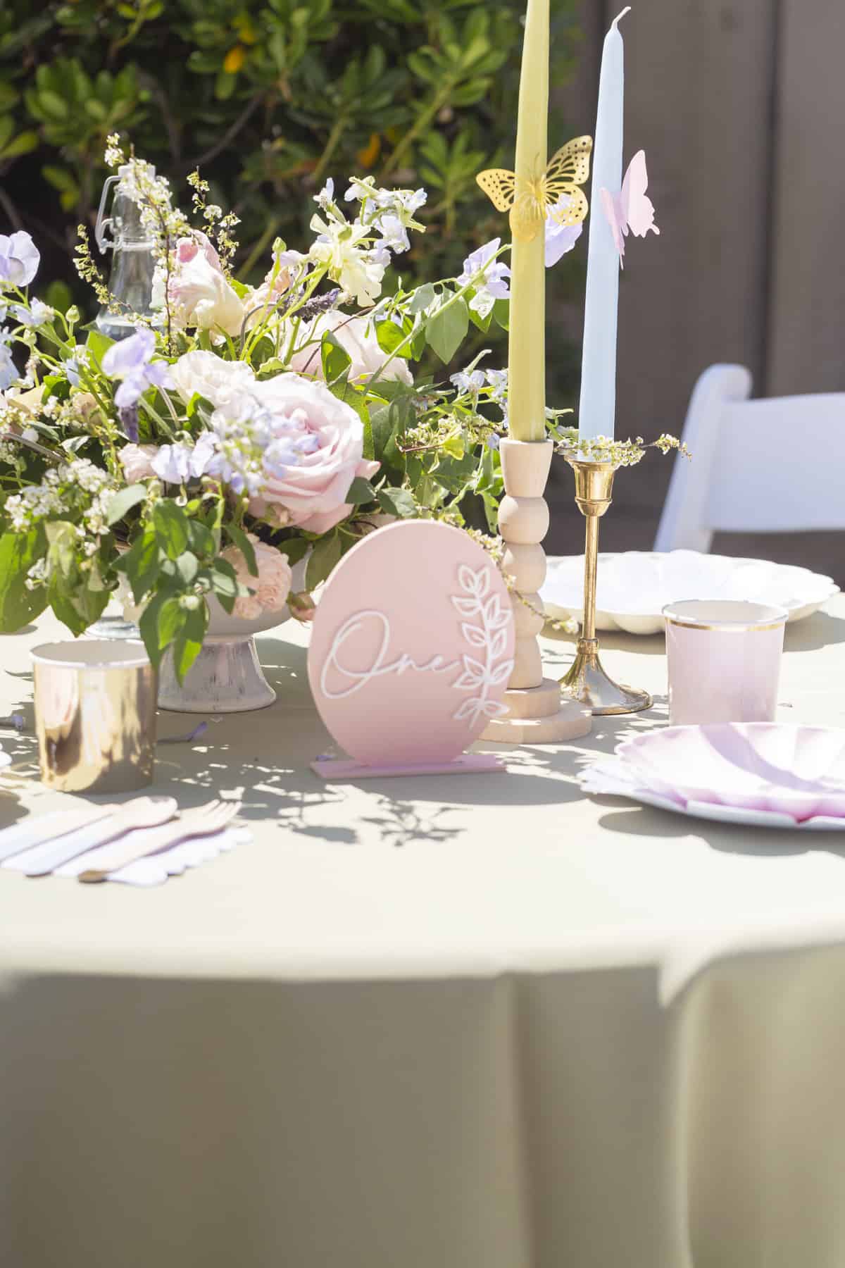 table setting with green tablecloth and lots of table setting with green tablecloth and lots of flowers and table signflowers and table sign