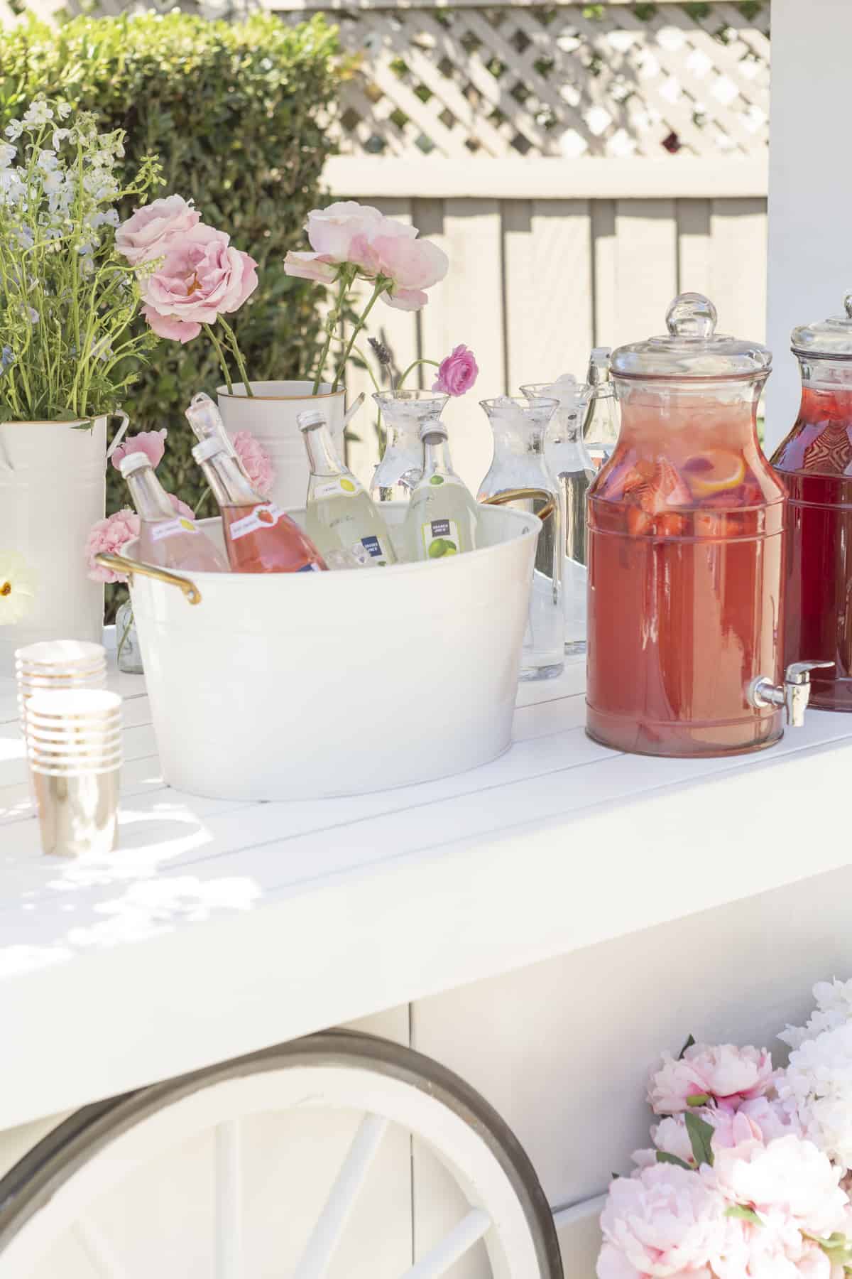 drink dispensers and a bucket on a white card with drinks inside